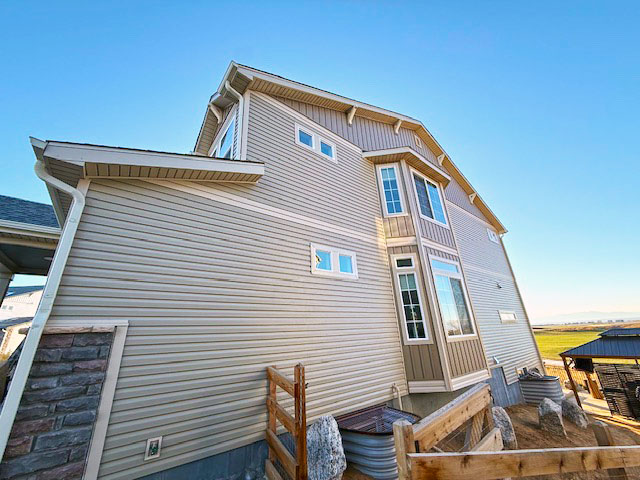 House wrap, siding, window trim, fascia, soffit, exterior paint, and roofing